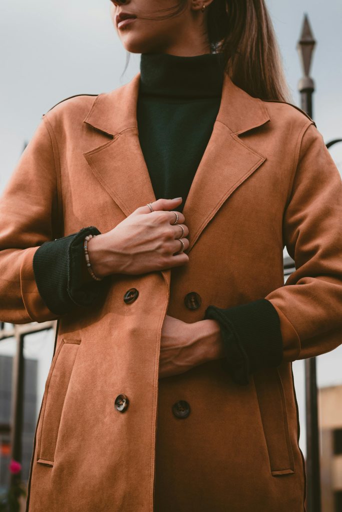 Person in Brown Trench Coat Wearing Black Turtleneck Top