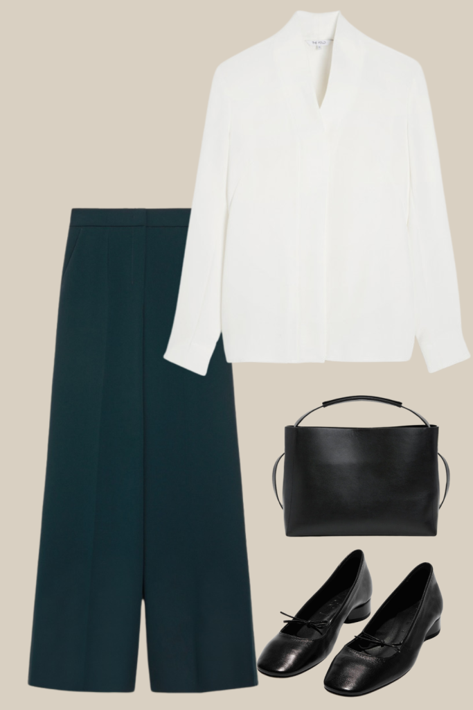 Elegant minimalist Thanksgiving outfit featuring a white blouse, dark wide-leg trousers, a structured black handbag, and black leather ballet flats. A sophisticated, understated style perfect for a chic holiday gathering.