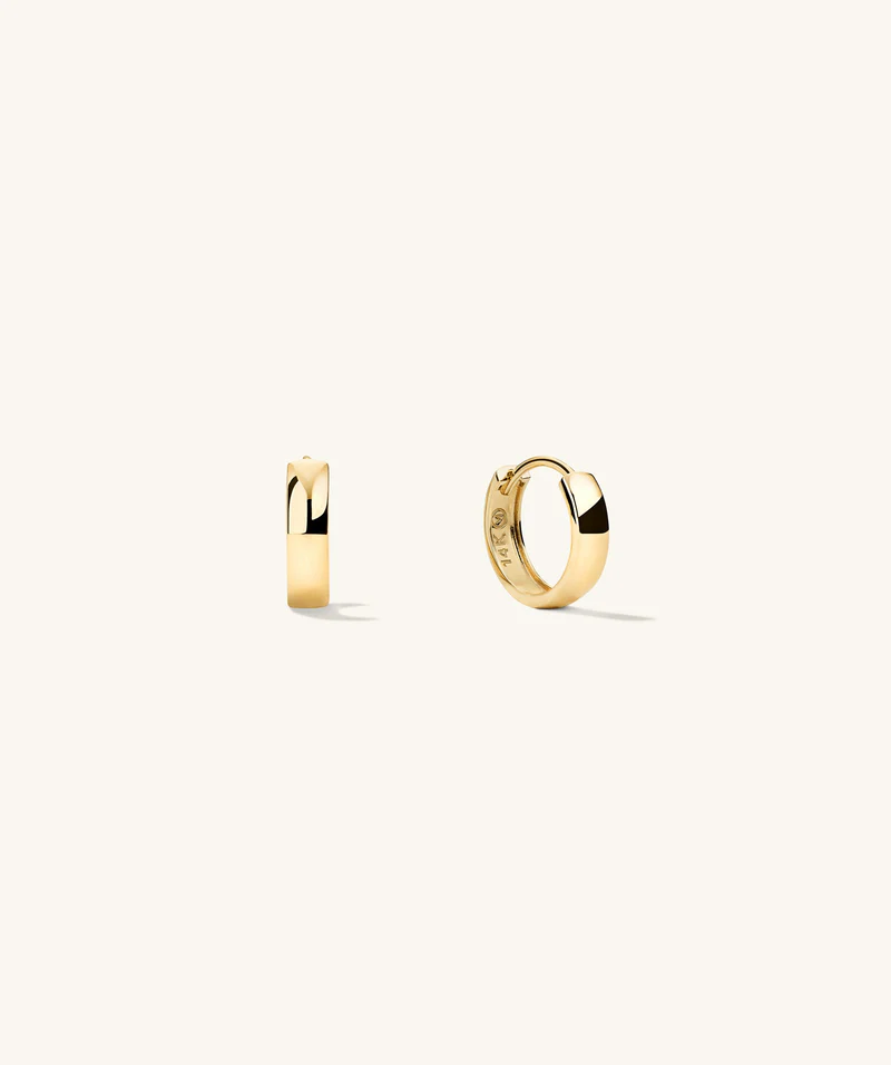 Simple yet elegant gold hoop earrings, a timeless accessory that adds a touch of refinement to any outfit.