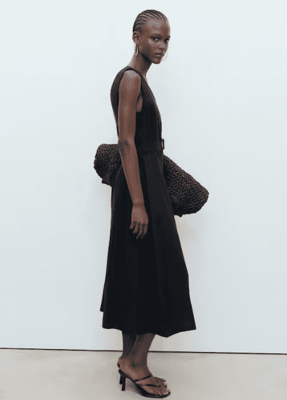 Sleeveless black midi dress with simple heels, clean lines and ease found in old money formal dresses