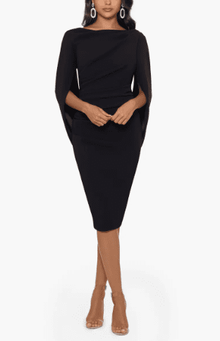 Black cape-style cocktail dress with minimal heels, refined silhouette typical of old money formal dresses