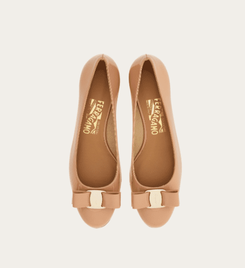 Beige ballet flats with simple bow detail, soft feminine design associated with old money shoe brands