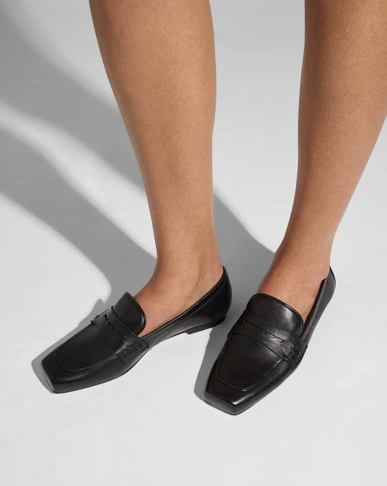 Black square-toe loafers worn casually, timeless everyday footwear linked to old money shoe brands