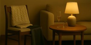 Warm editorial scene of a cozy living room corner with soft lighting, knitwear, a hint of silk, and a single champagne glass catching light, setting the mood for casual new years eve outfits.