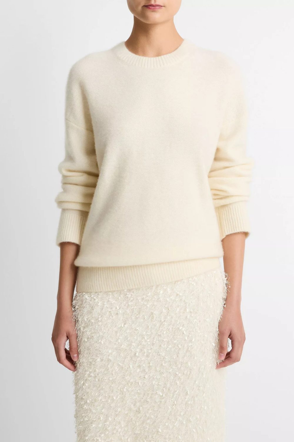 Soft creaml cashmere sweater paired with light skirt, showcasing quiet luxury from 7 Timeless Pieces to Start 2026 Right