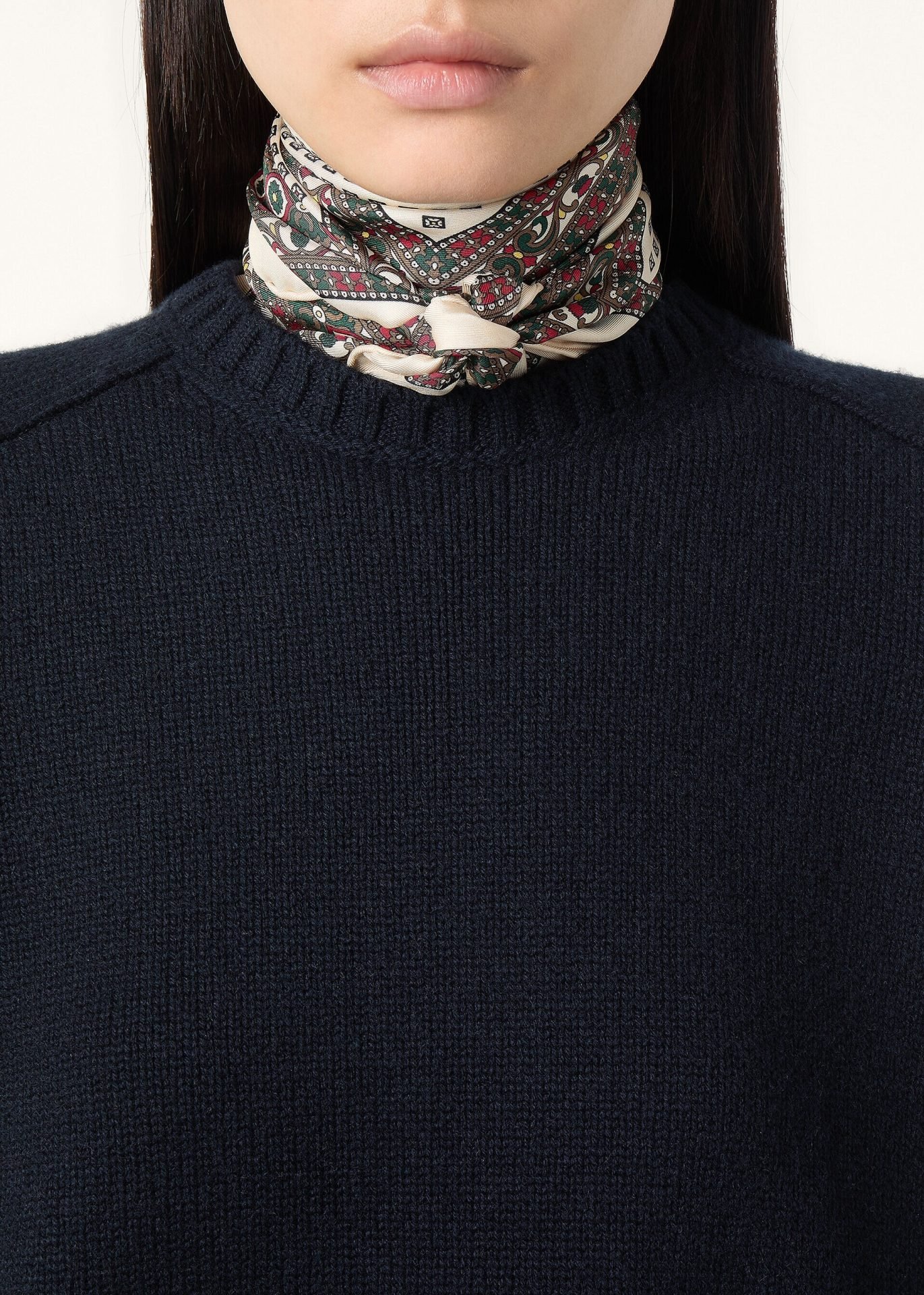 Navy knit sweater styled with a silk neck scarf, a refined layering detail for Capsule Wardrobe 2026 with timeless, elegant appeal