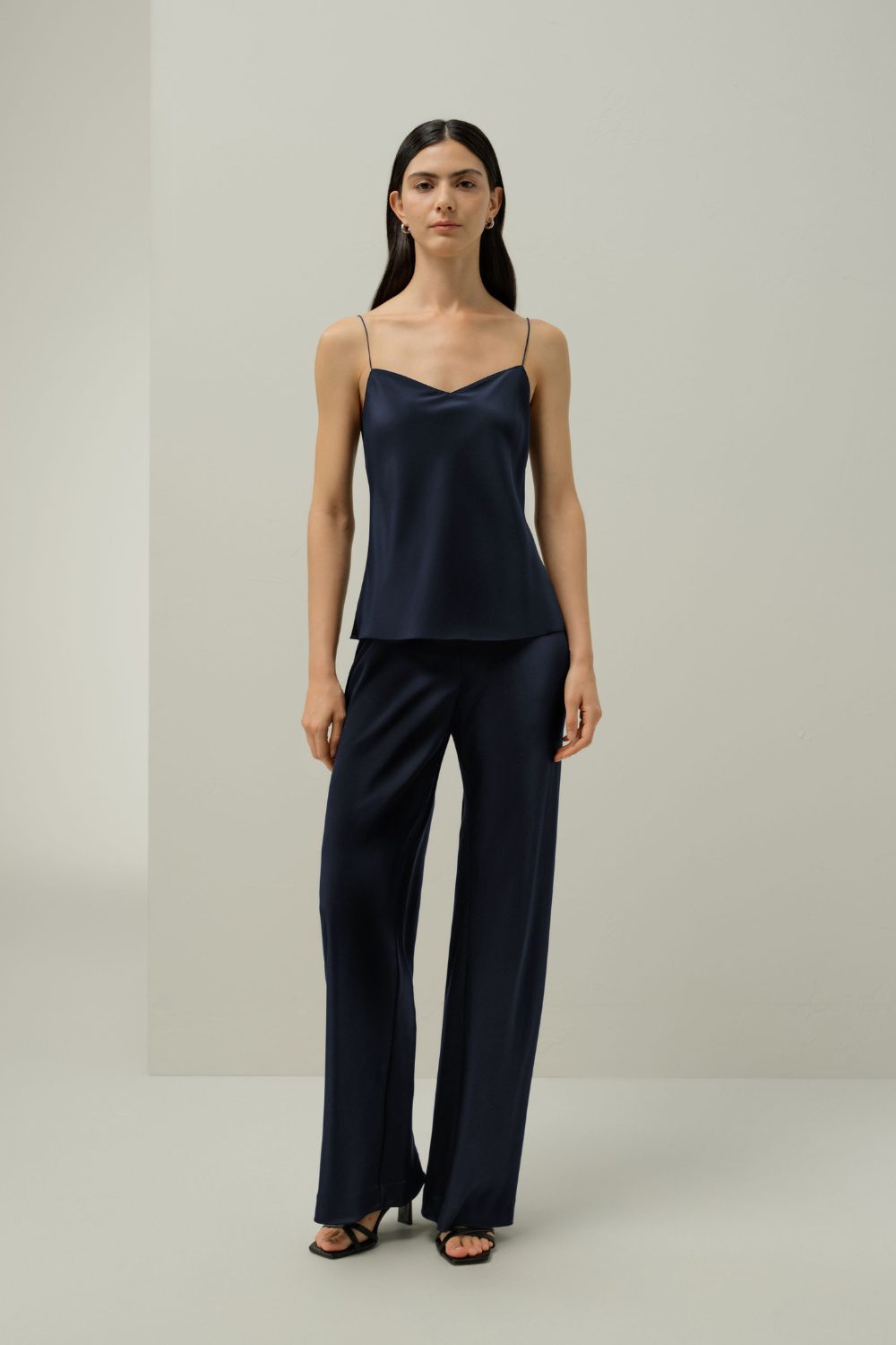 Navy silk camisole and trousers styled simply, demonstrating 7 Pieces That Make Any Outfit Look More Expensive