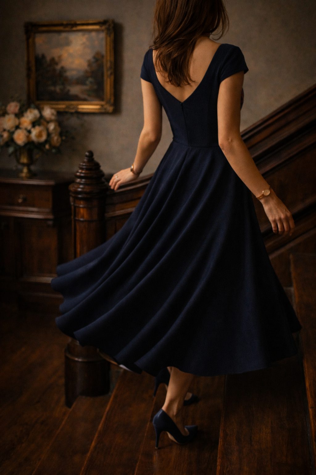Tea-length skirt twirls on a staircase softly capturing Elegant Valentine’s dresses in charming, timeless movement