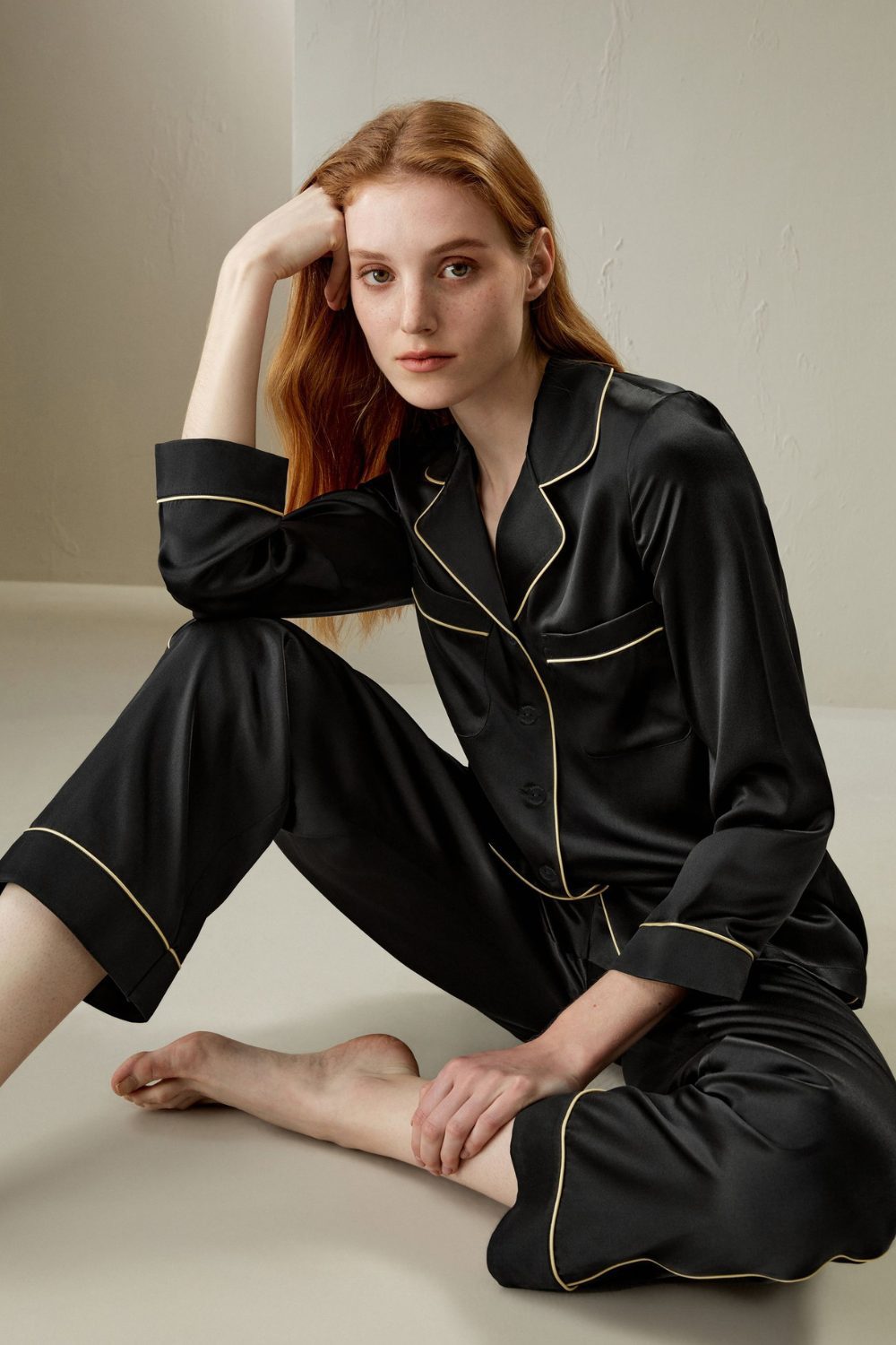 Black silk pajamas with contrast piping, elegant and comfortable. Timeless Valentine’s Gifts She’ll Love for night routines.