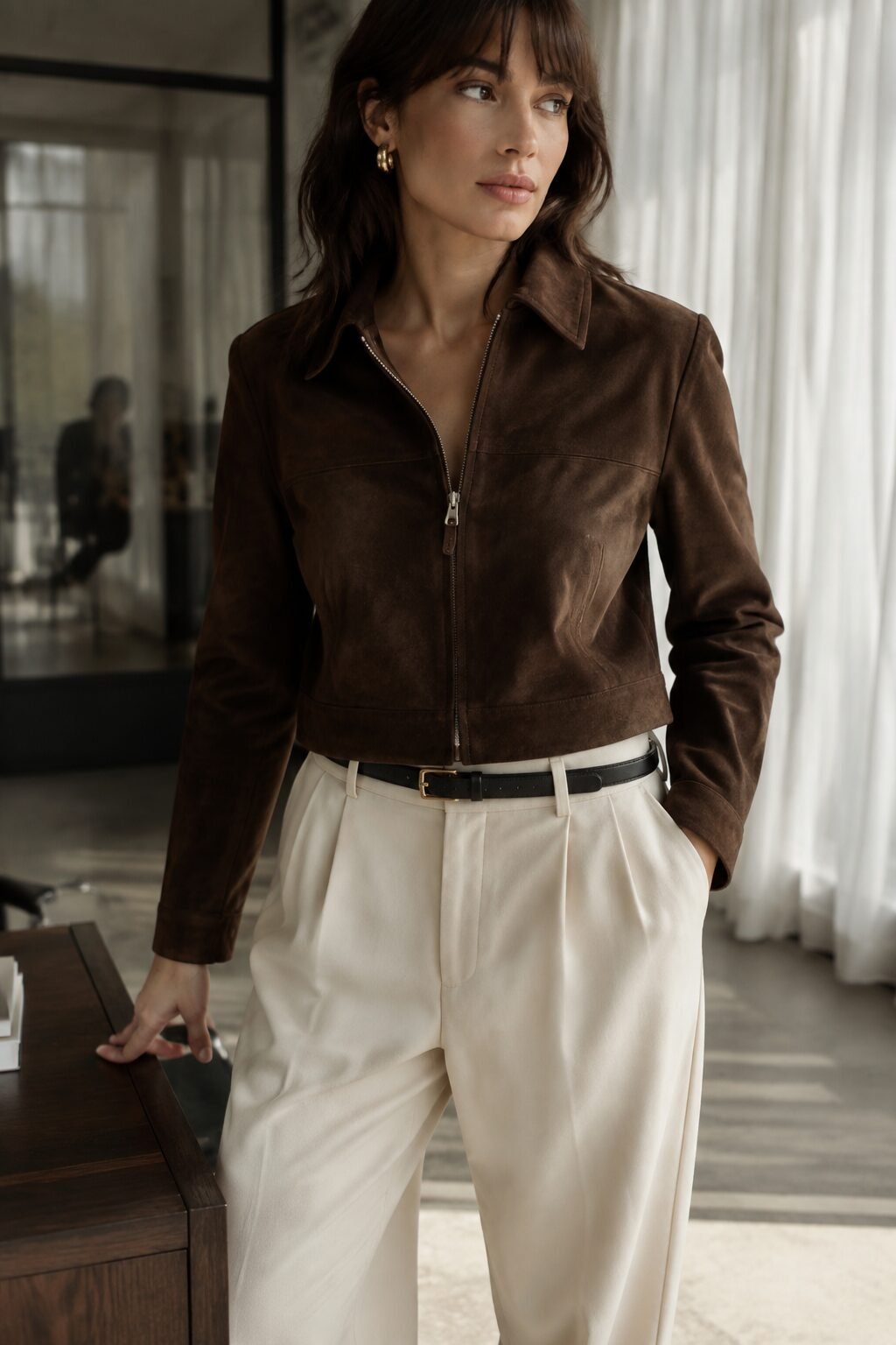 how to style a suede jacket with tailored trousers: chocolate suede jacket, ivory wide-leg trousers, and black loafers
