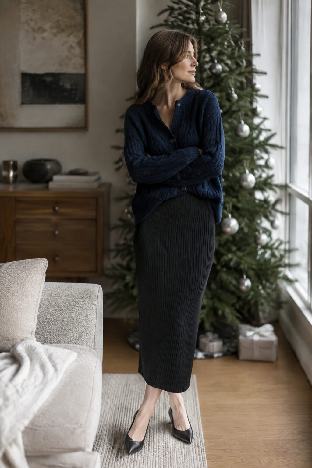 cool toned winter outfit: navy cashmere cardigan tucked into a black midi skirt for holiday family photos
