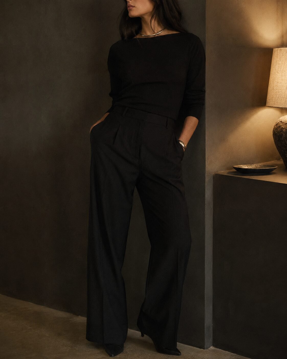 cheap christmas outfit look expensive: matte black trousers and top under evening light