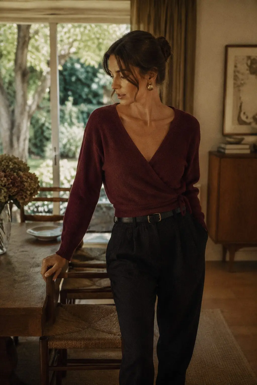 fall capsule wardrobe outfit idea: burgundy wrap sweater and black trousers for a Sunday family dinner