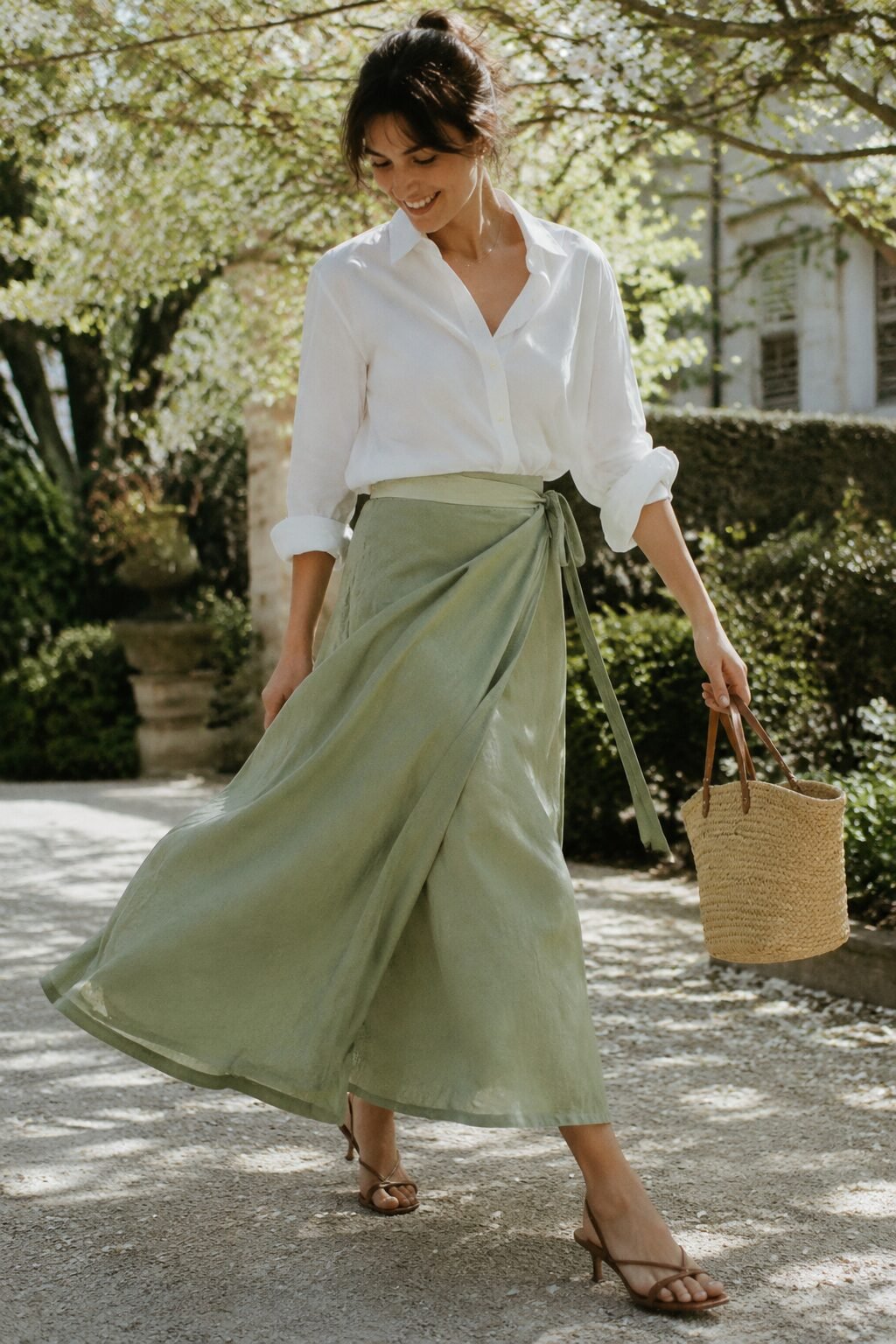 spring white shirt outfit: white shirt tucked into a sage green wrap midi skirt for a garden party