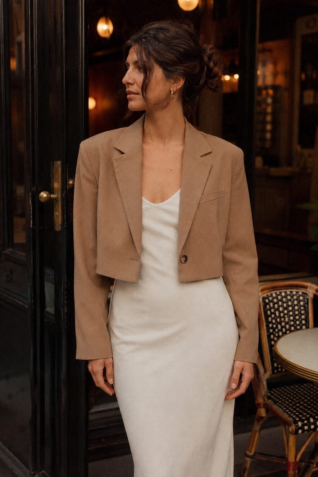 cropped camel blazer layered over an ivory slip dress, a 90s minimalist date night outfit