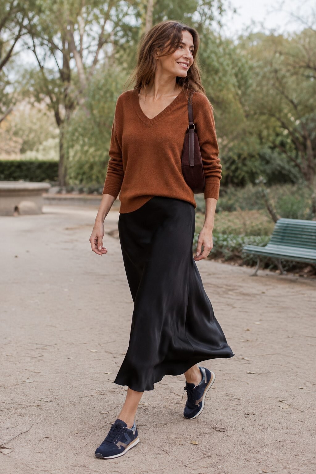 preppy sweater outfit: olive v-neck sweater with a navy skirt and navy sneakers
