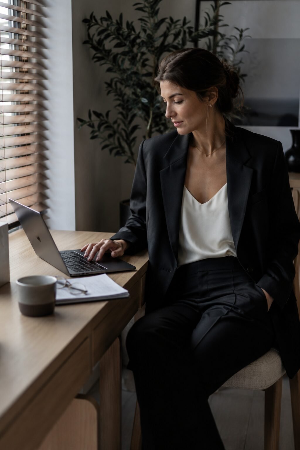 work from home capsule wardrobe video call outfit: black oversized blazer over white silk camisole with black micro flare pants