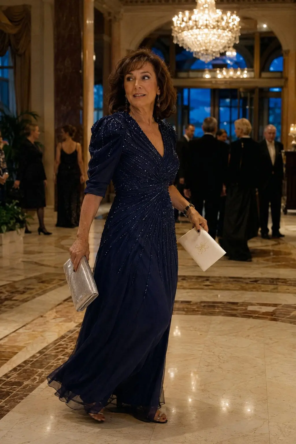 navy beaded chiffon gown with puffed sleeves and a silver clutch for a black-tie ballroom mother of the groom outfit