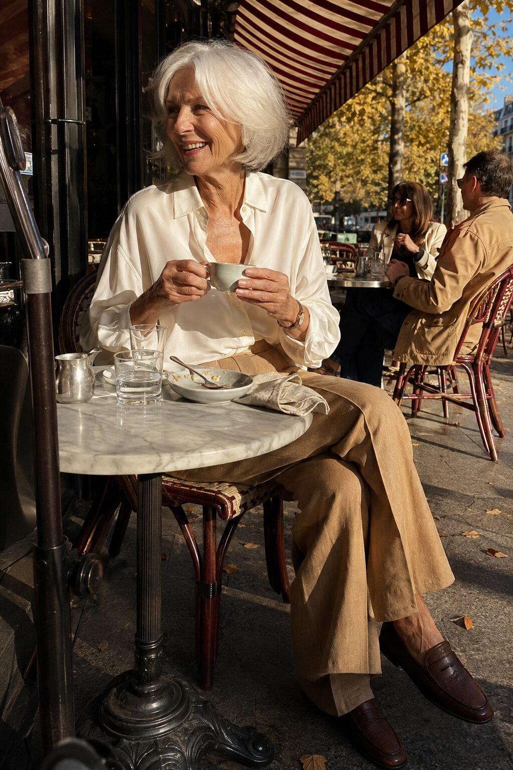 how to dress in your 70s: ivory washable silk blouse and camel wide-leg linen trousers with a coffee loafer