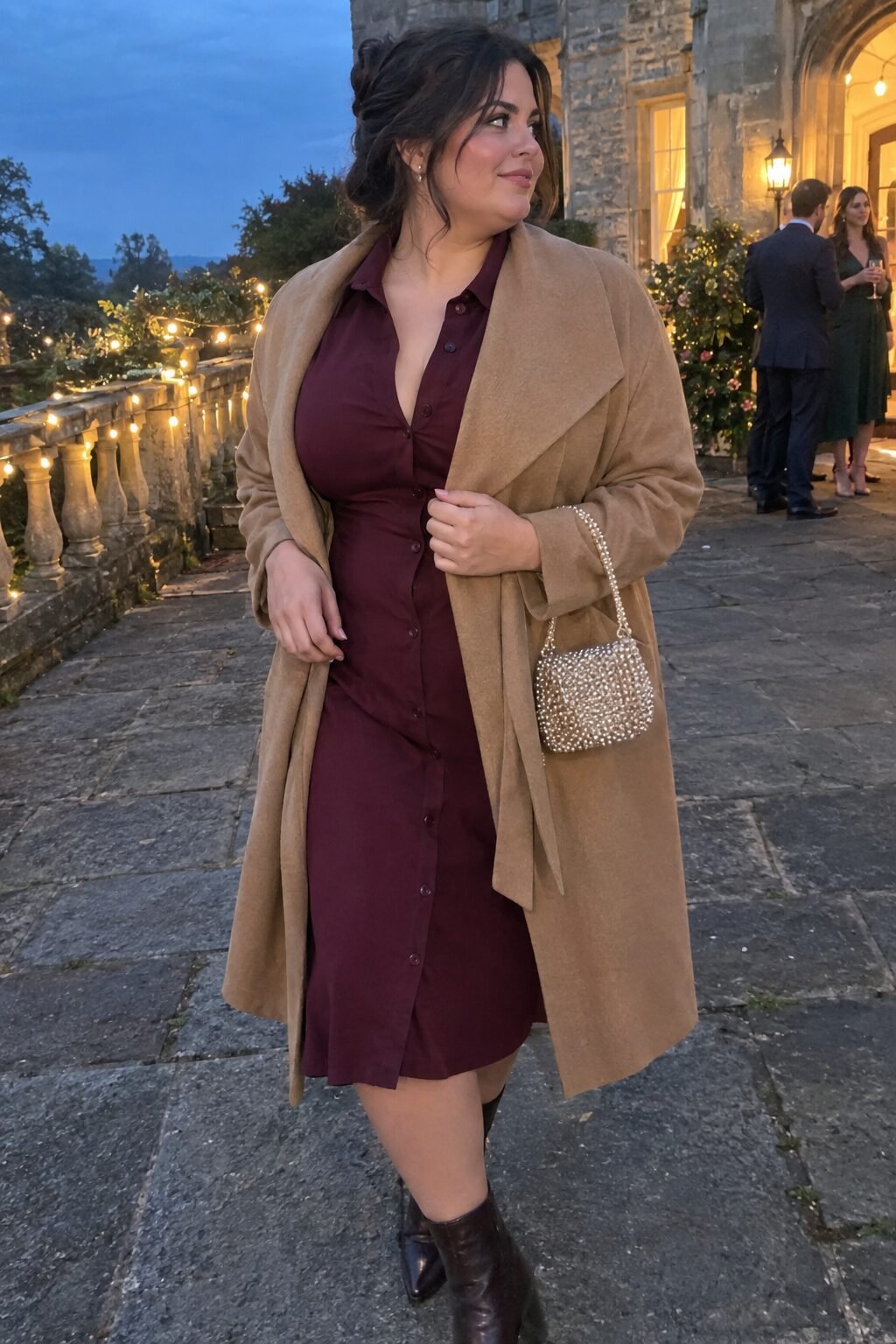 fall wedding guest outfit: wine-toned shirt dress under a camel wool wrap coat