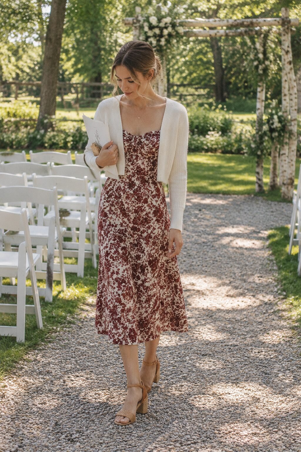 fall wedding guest outfit: rust floral midi dress with ivory cropped cardigan and block heel sandals