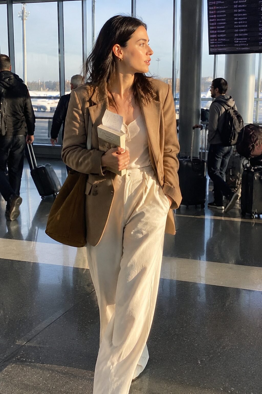 elegant airport outfit: camel blazer and cream wide-leg trousers for a short flight