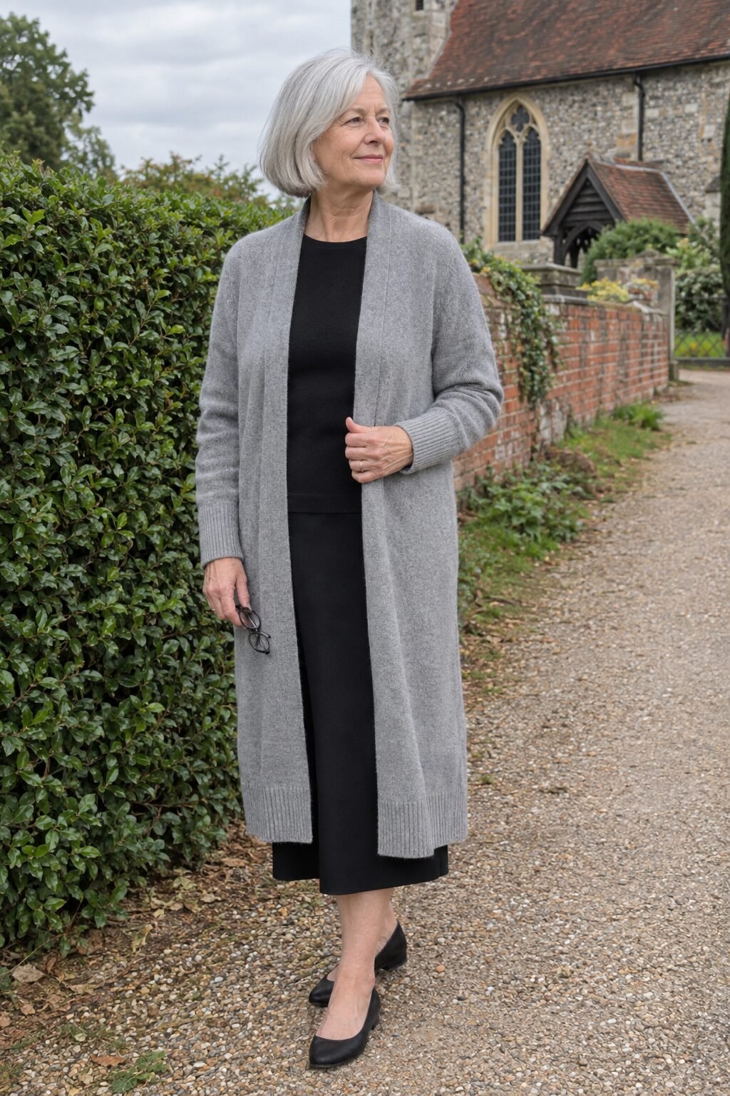 church outfit for women in their 70s: heather grey cashmere duster cardigan over a long black washable silk maxi skirt