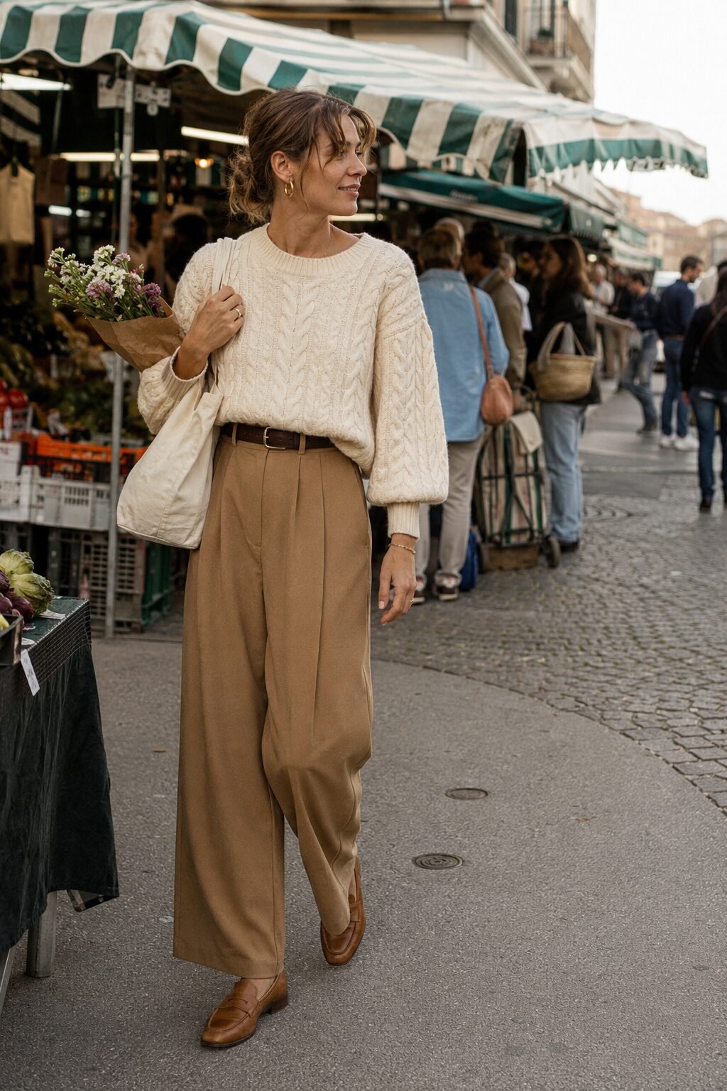 camel and cream fall outfit idea: cream cable-knit sweater tucked into high-waisted wide-leg camel trousers with loafers