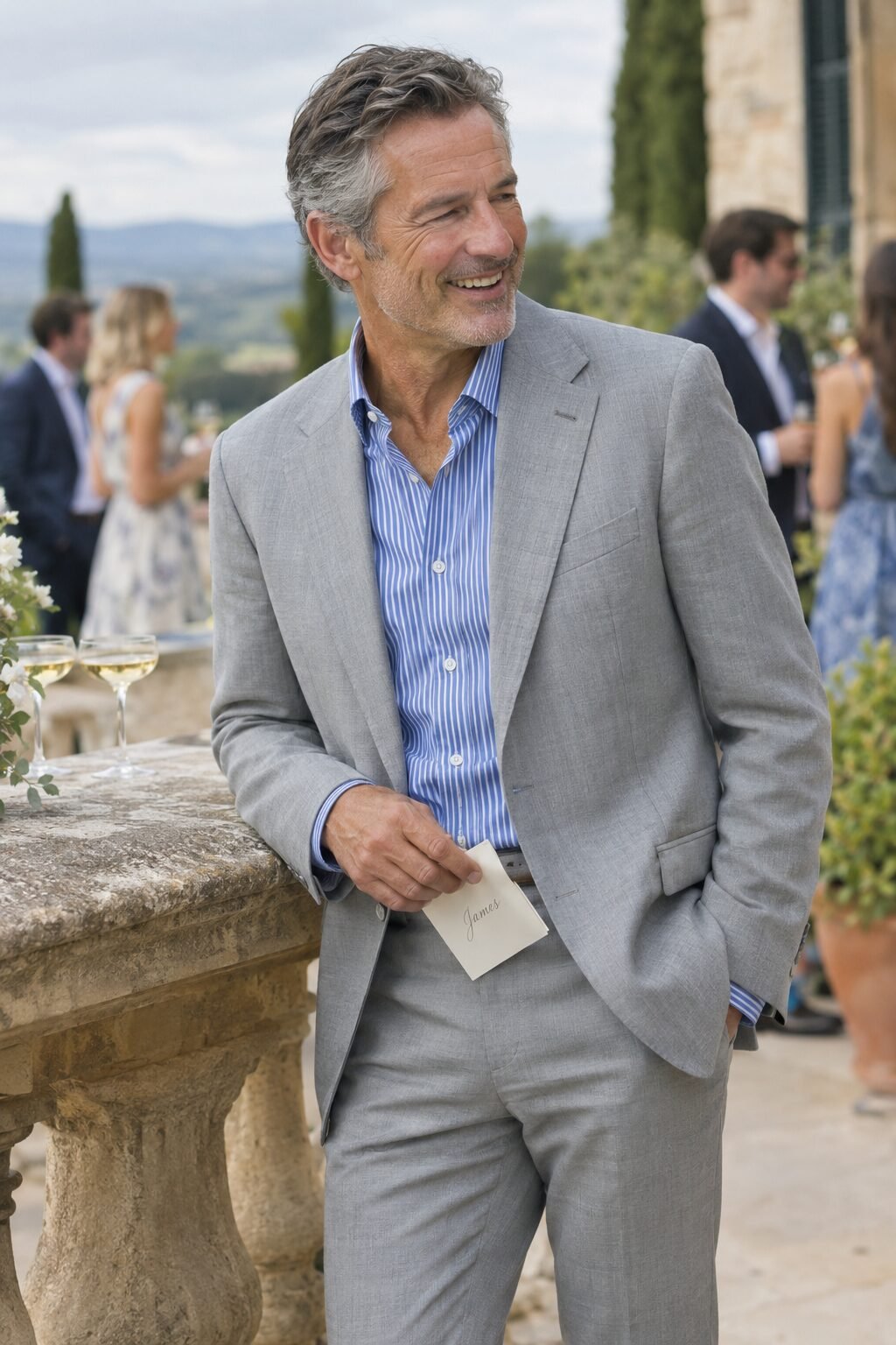 wedding guest attire for men over 50: light grey suit with blue striped dress shirt for a semi-formal wedding