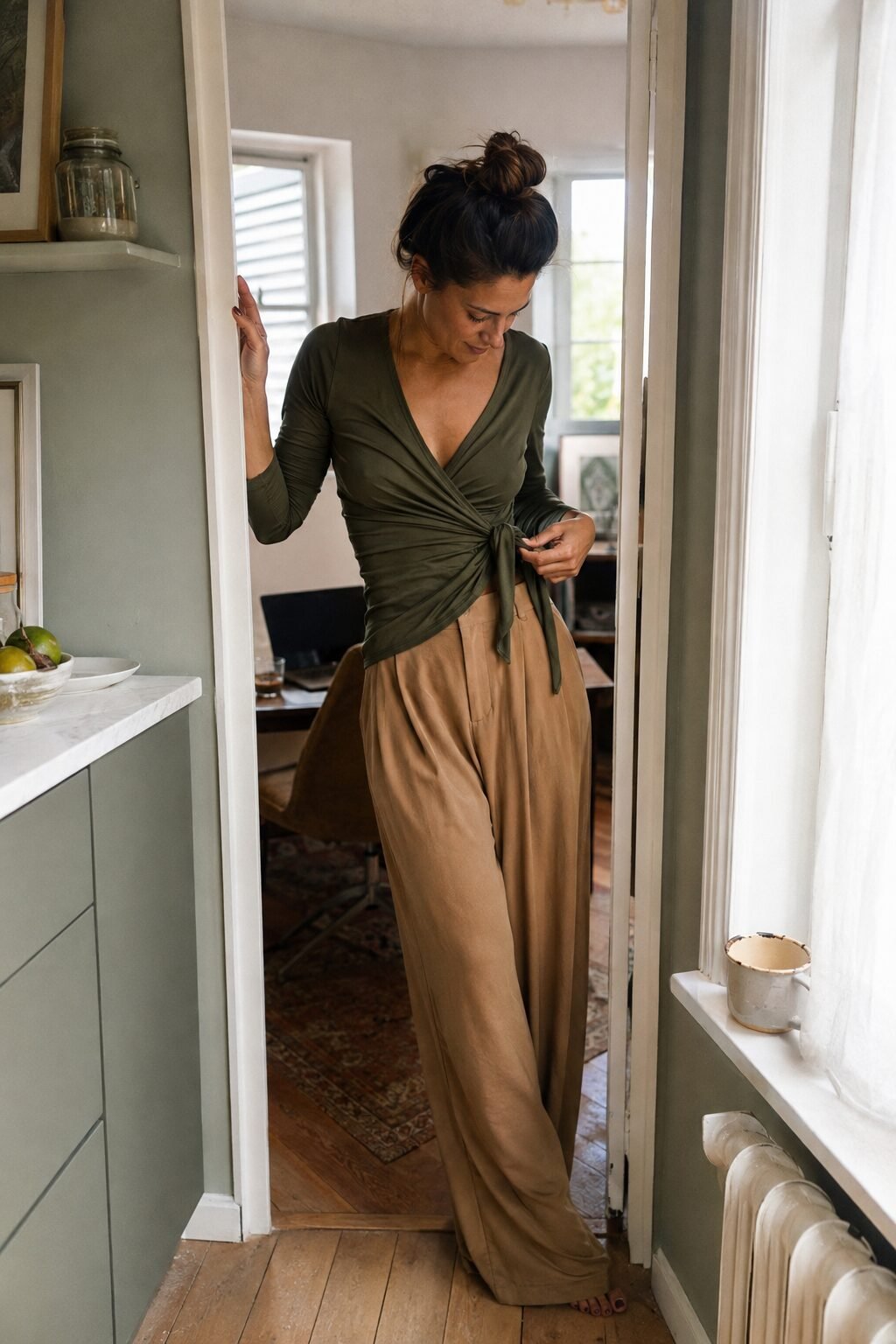 no-iron work outfit for the office: olive matte jersey wrap top tucked into camel wide-leg trousers