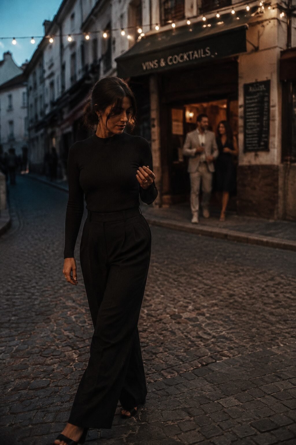 elegant all black halloween outfit: knit bodysuit tucked into wide-leg trousers