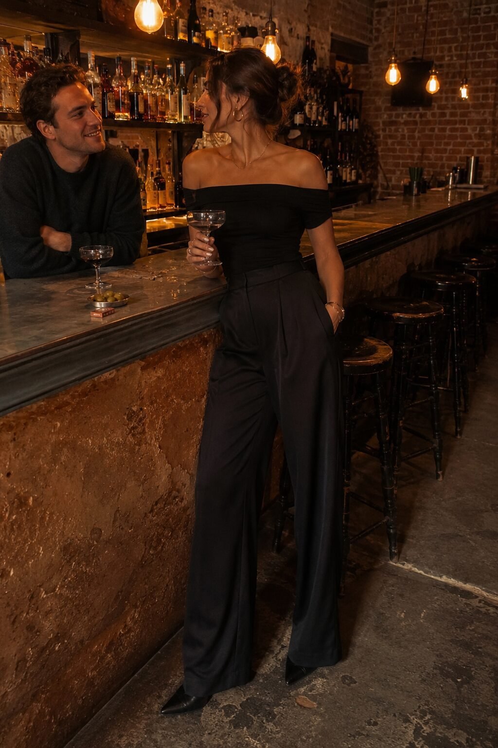 romantic halloween date night look: black off-shoulder top tucked into black silk wide-leg trousers