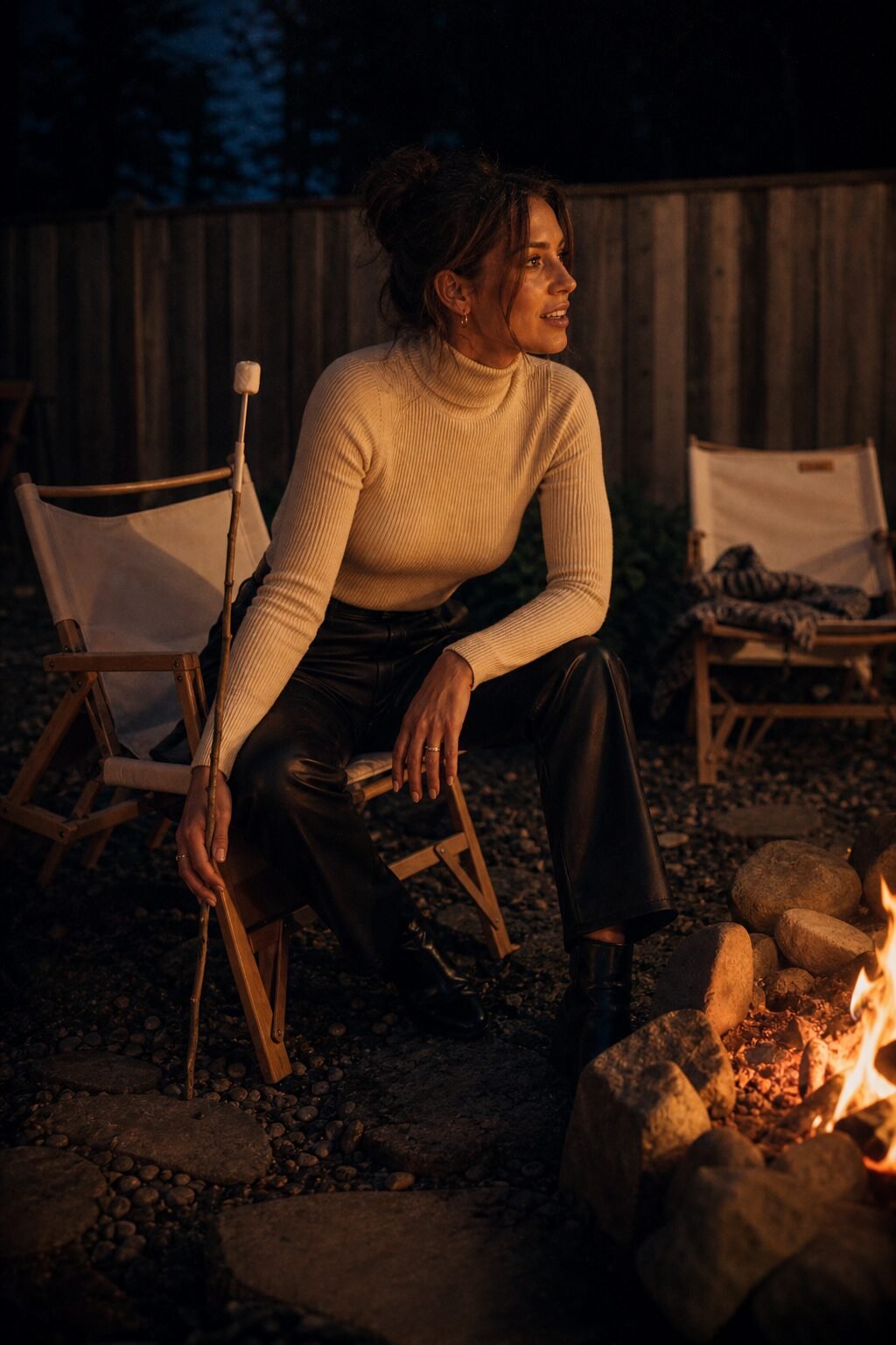 casual halloween party outfit: ecru turtleneck sweater tucked into faux leather trousers