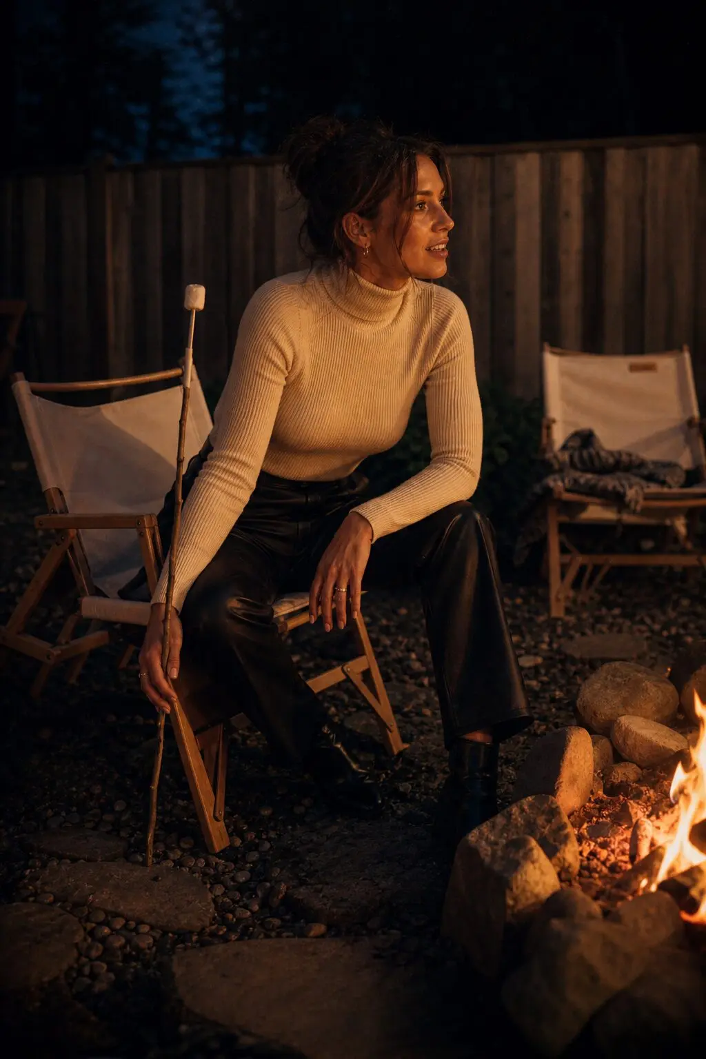 casual halloween party outfit: ecru turtleneck sweater tucked into faux leather trousers
