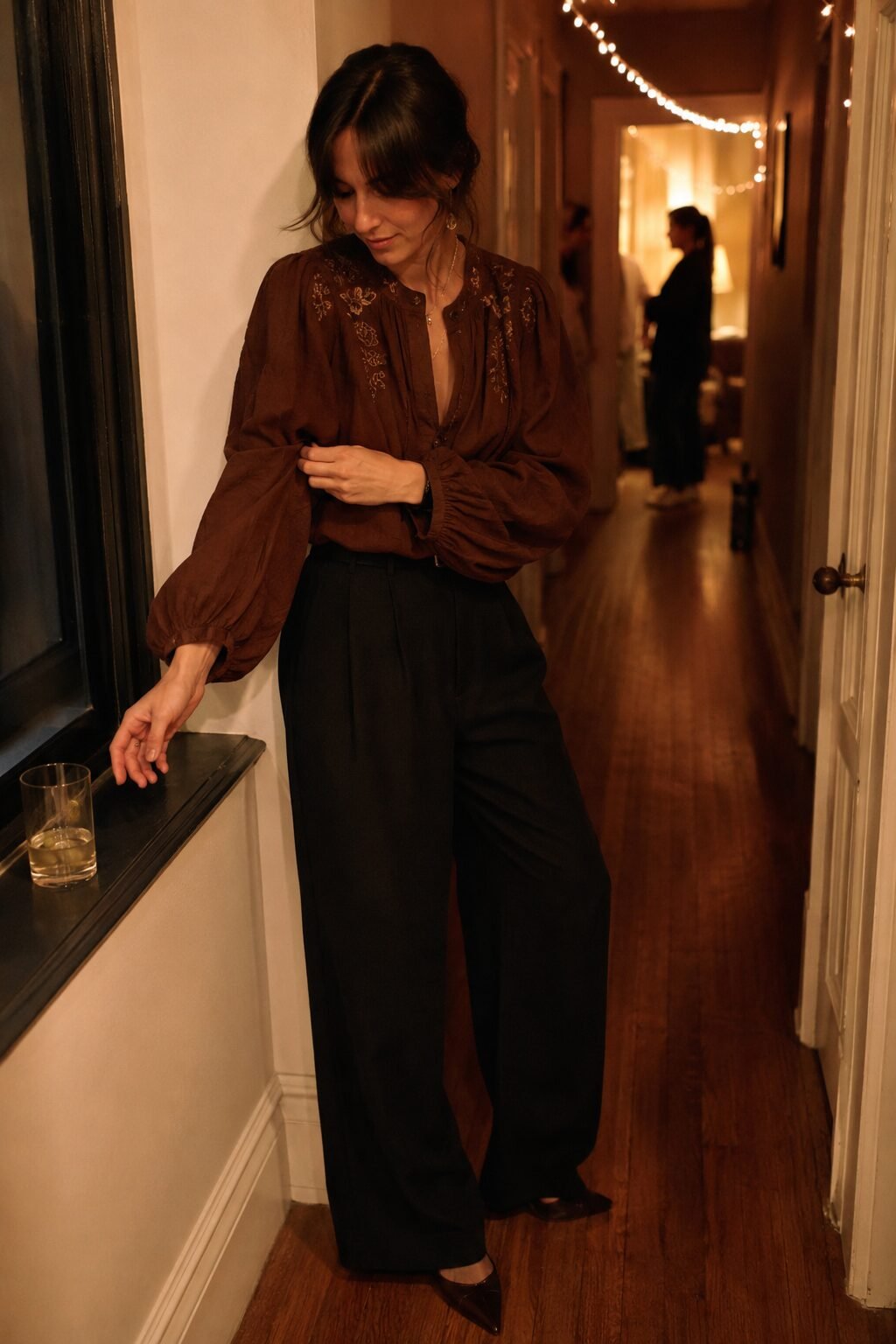 black wide-leg trouser and chestnut embroidered statement-sleeve blouse, an elegant halloween outfit idea with no costume