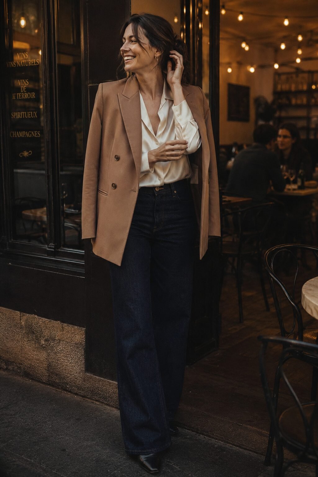 effortlessly rich camel and cream outfit: double-breasted camel blazer over a cream silk blouse and dark denim