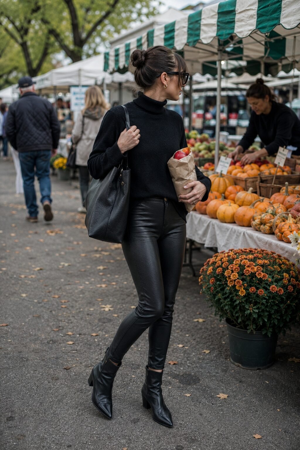 casual weekend outfit from a black capsule wardrobe: cashmere turtleneck, faux leather leggings, ankle boots, leather tote