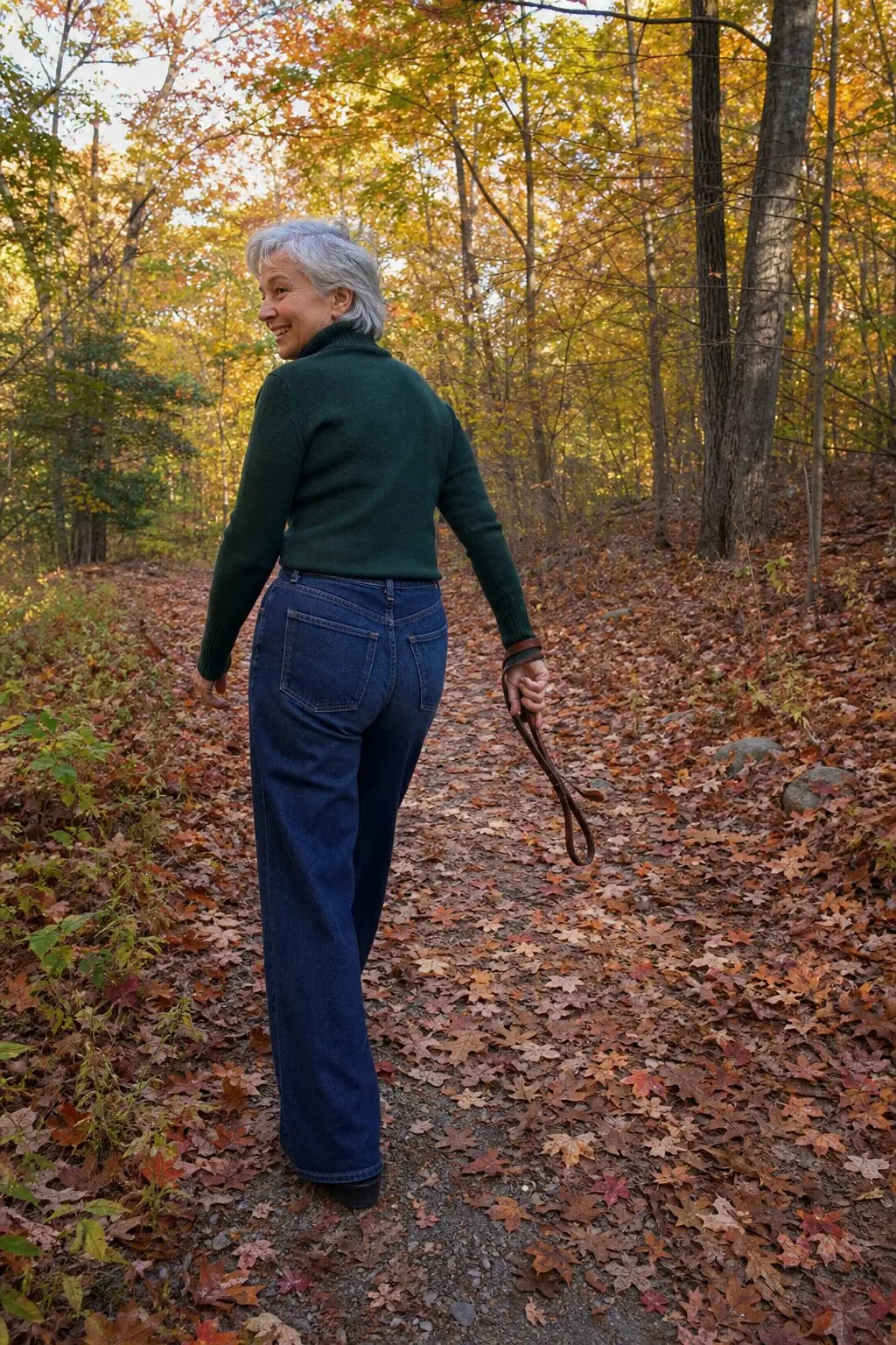 fall foliage walk outfit for women in their 70s: pine green turtleneck and wide-leg jeans
