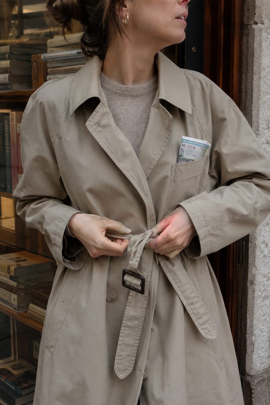 timeless style vs trendy fashion: beige trench coat, cashmere crewneck sweater, and pleated plaid midi skirt