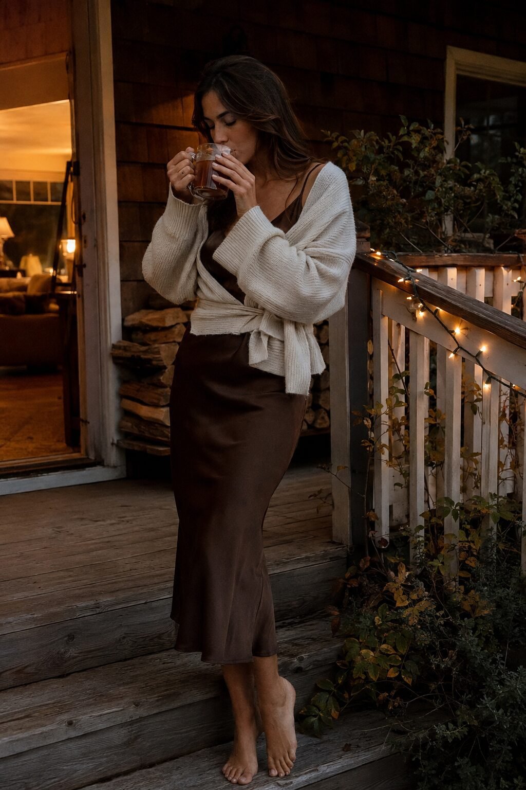 casual elegant halloween outfit: chocolate brown silk slip dress layered under an ivory wrap sweater