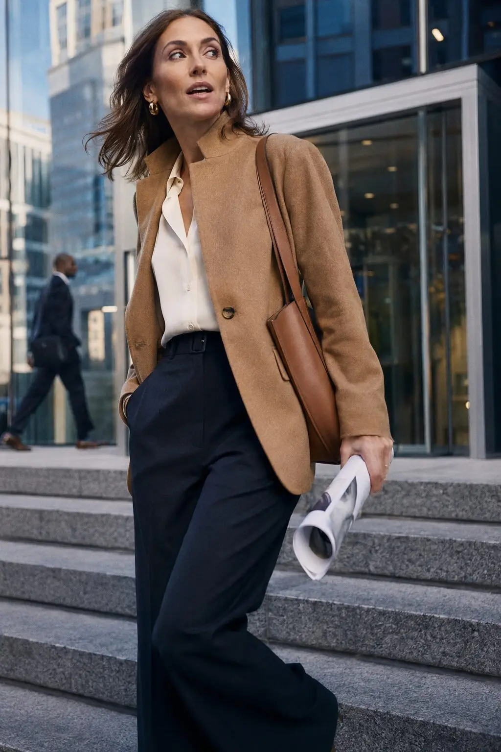 minimal effort work capsule outfit: camel wool blazer, off-white silk blouse, black wide-leg trousers, and saddle leather tote