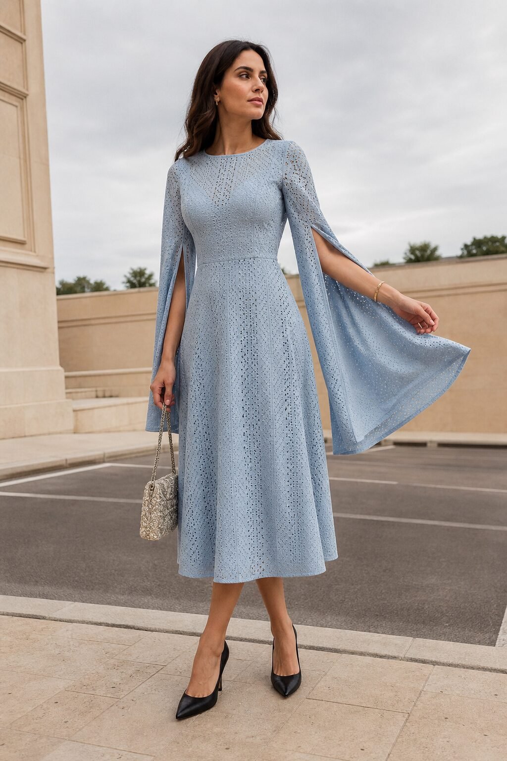 wedding guest outfit with gold bracelet: cameo blue cape-sleeve midi dress and black pointed pumps for a formal wedding