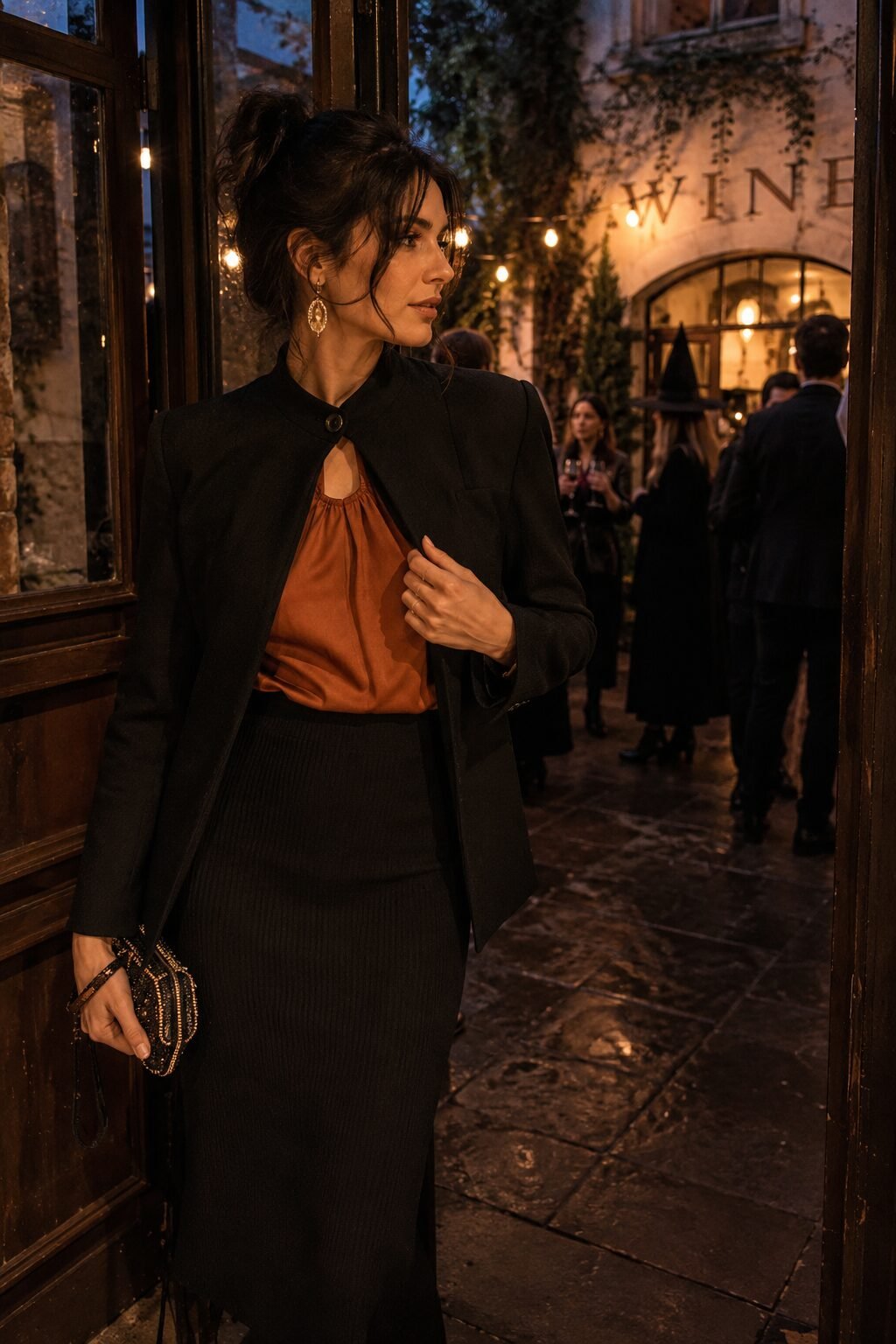 Halloween week capsule wardrobe Thursday evening outfit: rust silk halter under a black blazer, cashmere midi skirt, and statement earrings
