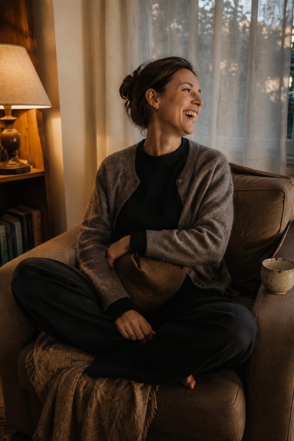 end of day work from home outfit: black cashmere sweater and black wide leg ponte pants layered under a grey alpaca cardigan