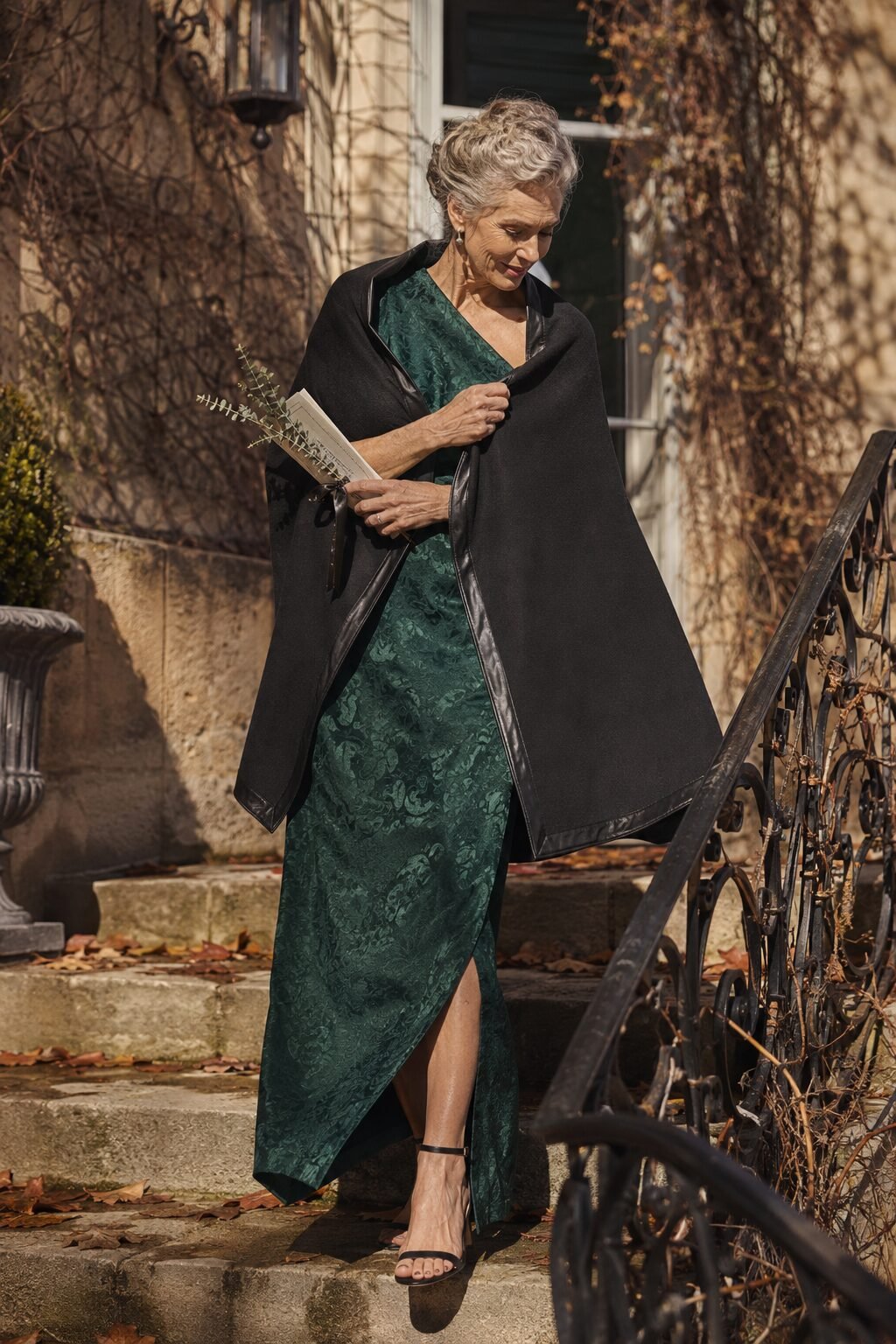 emerald jacquard gown with a black tie-front ruana wrap for a fall or winter mother of the groom outfit