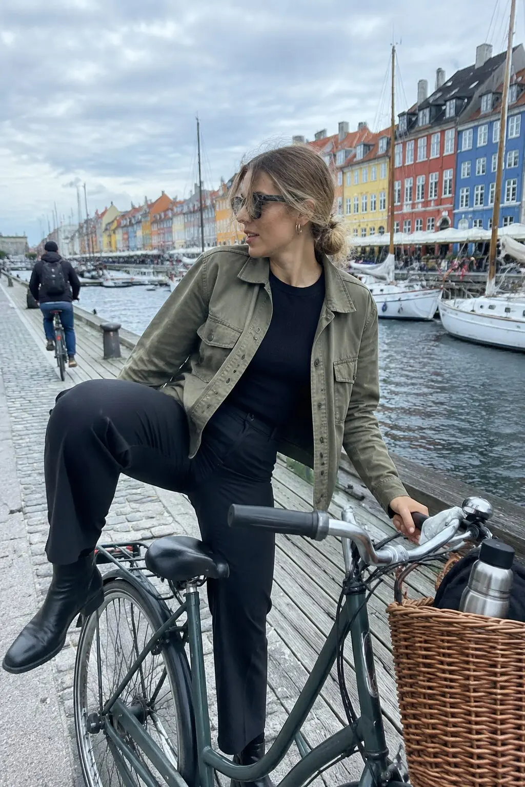 european fall outfit: olive utility shirt-jacket with black ankle boots for a bike commute