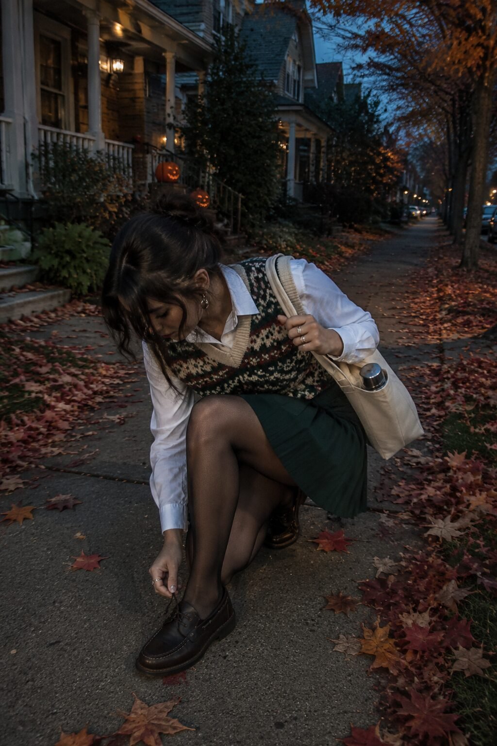 old money halloween outfit for trick-or-treating: fair isle sweater vest over collared shirt with pleated skirt