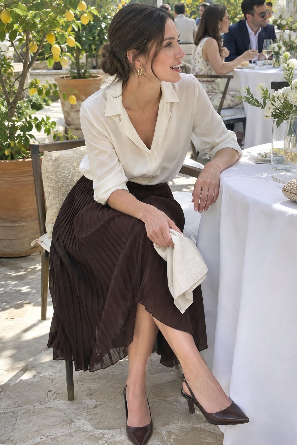 brunch wedding guest outfit: ivory silk blouse with dark brown pleated midi skirt