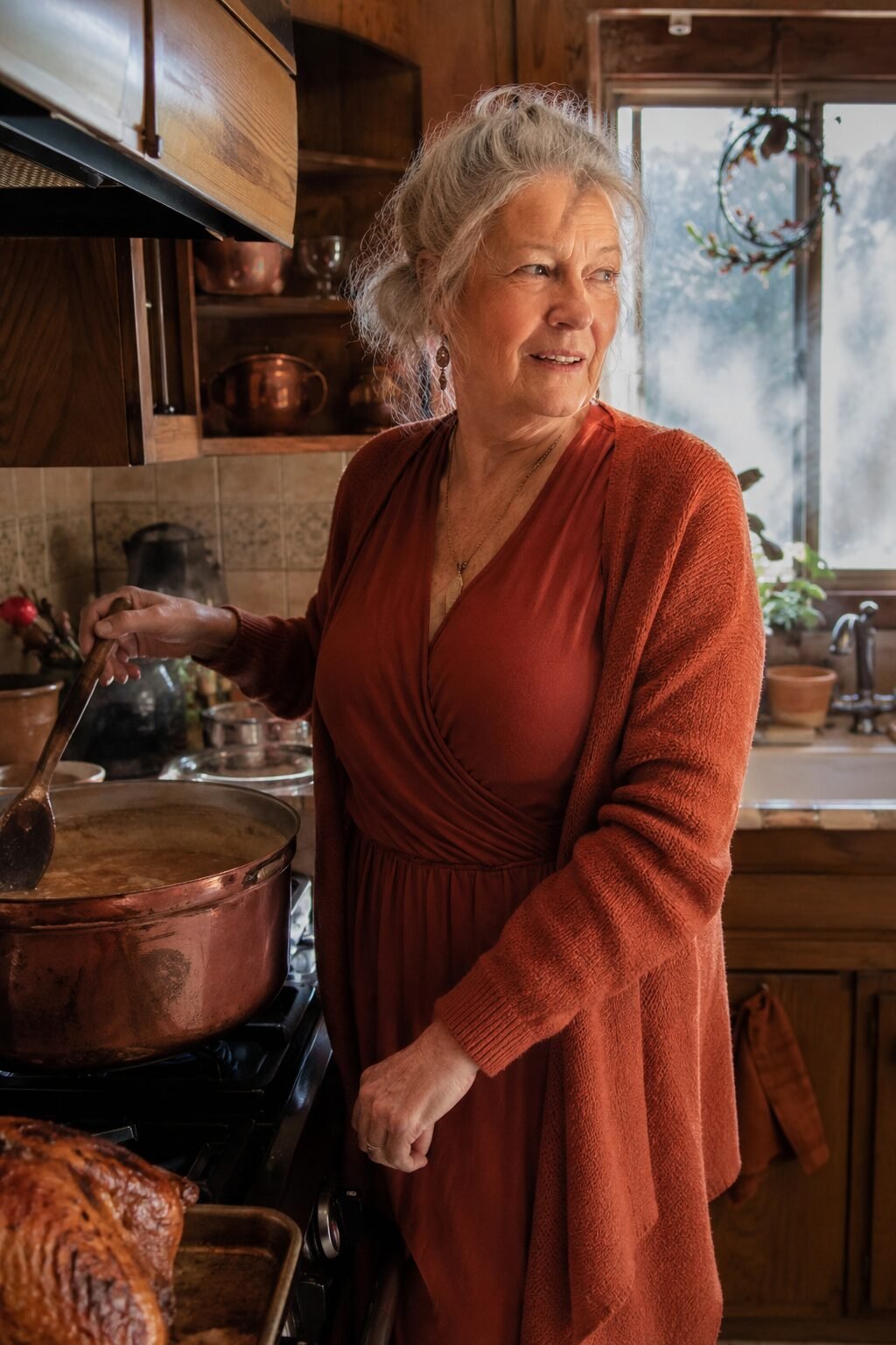 thanksgiving outfit for women in their 70s: rust faux-wrap knit dress and terracotta cardigan for hosting Thanksgiving dinner