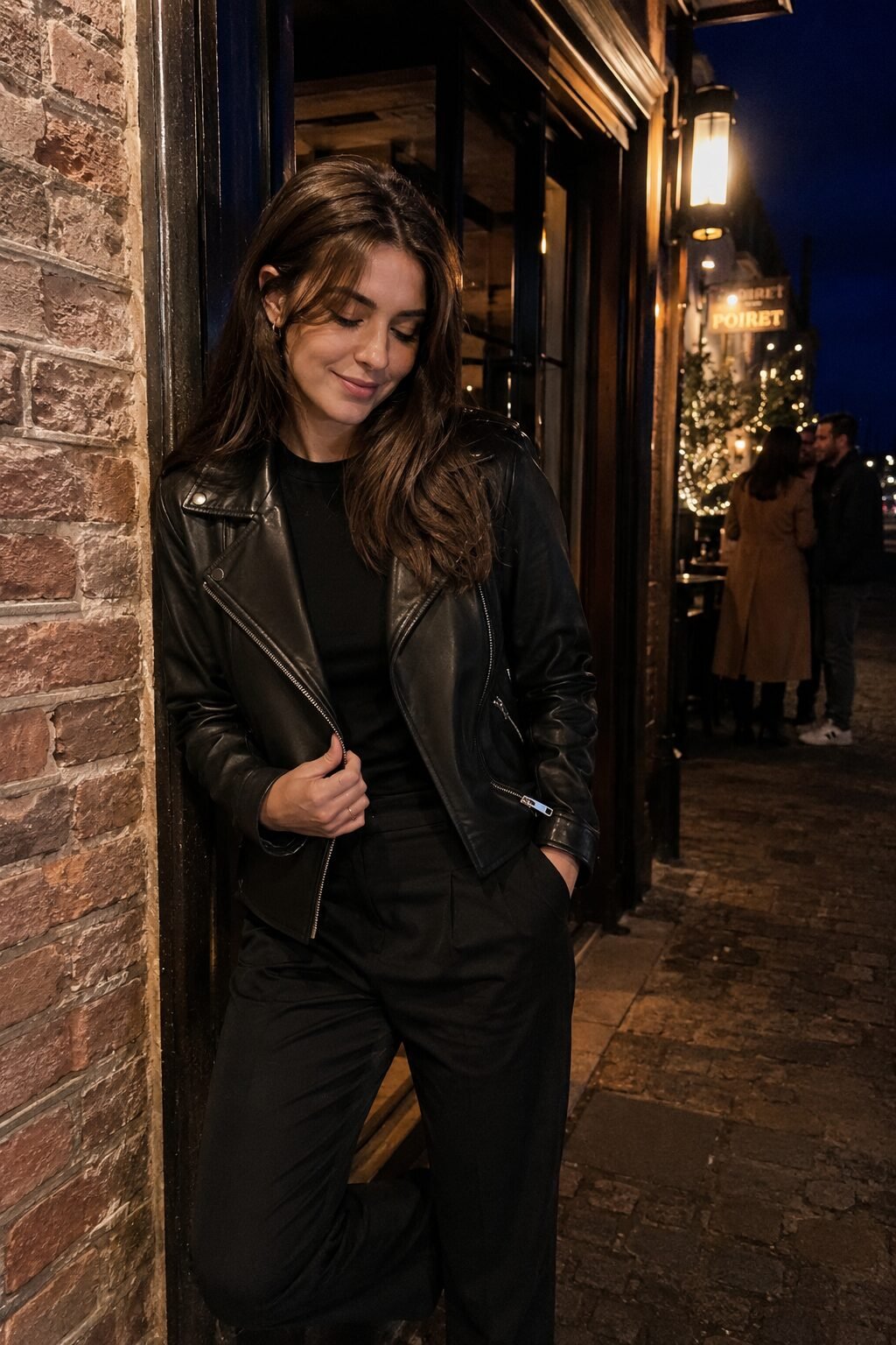 sophisticated all black halloween outfit: leather biker jacket with straight-leg trousers